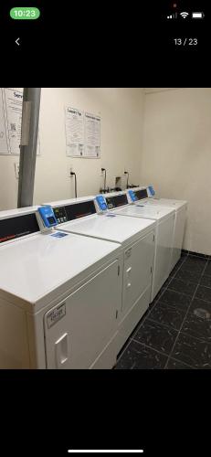 a counter in a room with two washing machines at Miami Sunny Isles Beach Ocean Front Resort Condo with balcony Pool, Beach,Gym,Valet Parking in Sunny Isles Beach