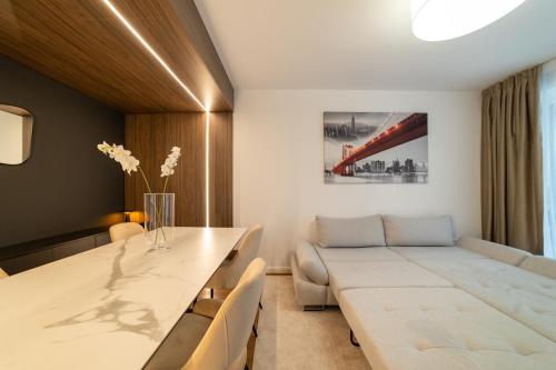 a living room with a table and a couch at Apartament Storyland in Braşov