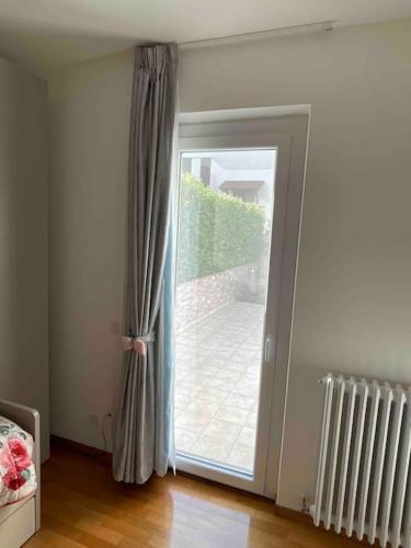 a sliding glass door leading to a patio at Villetta familiare a Potenza Picena in Potenza Picena