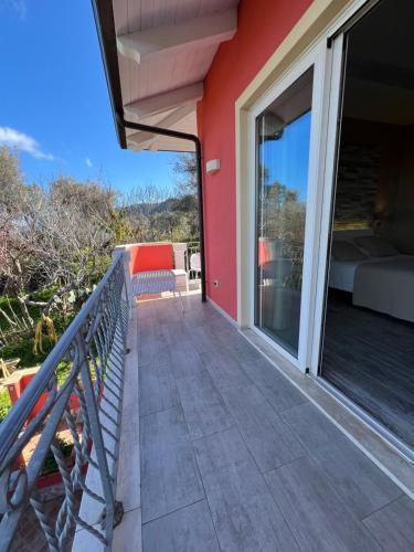 a balcony of a house with a bed and a window at Borgo di Santa Barbara in Santa Domenica