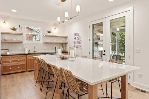 a kitchen with a large white table and chairs at Basecamp Retreat TimsFordLake in Winchester
