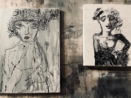 two drawings of a man and a woman on a wall at Lets Go - Apartment in Tbilisi City
