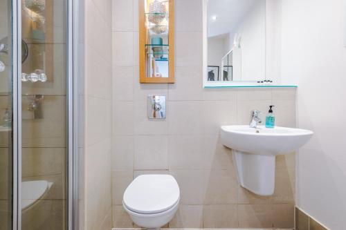 a bathroom with a toilet and a sink and a shower at Stylish and Comfy Studio in Sheffield City Centre in Sheffield