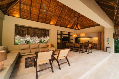 a living room with a couch and a table at Naio Hotel y Villas By OxoHotel in Palomino