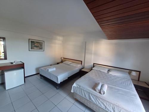 a hotel room with two beds and a sink at Apart-Hotel em Tambaú - Super Central com Vista Mar - Ap.113 in João Pessoa