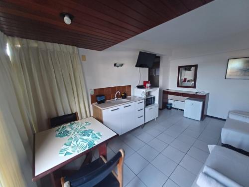 a kitchen and dining room with a table and a sink at Apart-Hotel em Tambaú - Super Central com Vista Mar - Ap.113 in João Pessoa