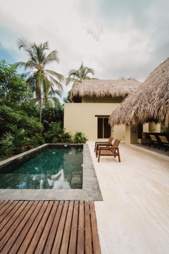 a villa with a swimming pool and a resort at Naio Hotel y Villas By OxoHotel in Palomino