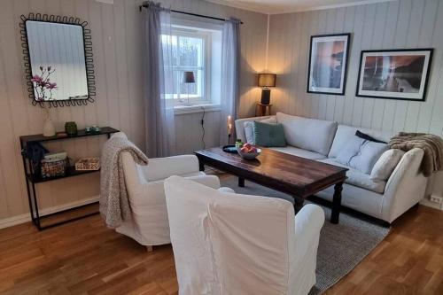 a living room with a couch and a table at Leilighet på Bekkeli, Beito. in Beitostøl