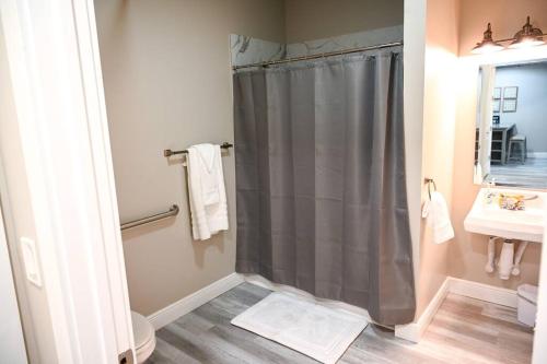 a bathroom with a shower and a toilet and a sink at The Borden Room in Biloxi