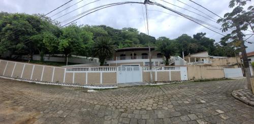 a white fence in front of a house at Casa Praia dos Sonhos in Itanhaém