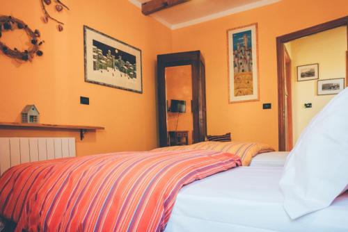Un dormitorio con una cama con una manta a rayas. en B&B del Villaggio, en Argentera