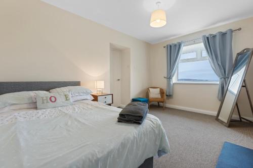 a bedroom with a bed and a large window at Sperrin Mountain Escape in Derry Londonderry