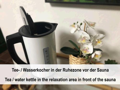 a cup with a knife and flowers in a basket at Haus mit Sauna und privatem Badeteich in Anif bei Salzburg in Anif