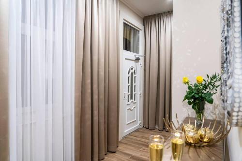 a room with a table with a vase of flowers on it at Apartment 4 in Budapest