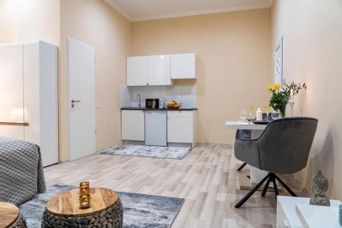 a living room with a table and a kitchen at Apartment 4 in Budapest