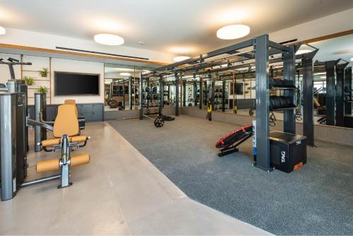 a gym with a lot of equipment in a room at Sun Berry Waikiki Residence in Honolulu