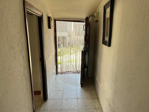 a hallway with a door leading to a door way with a window at Casa Rural El Reloj in Salobralejo