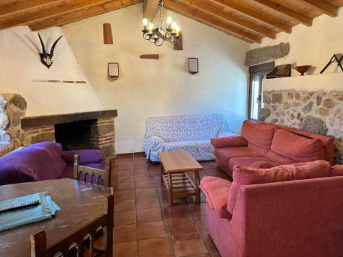 a living room with a couch and a fireplace at Casa Rural El Reloj in Salobralejo