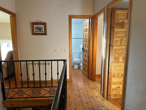 a hallway with a staircase leading to a bathroom with a toilet at Casa Rural El Reloj in Salobralejo