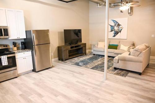 a kitchen and living room with a couch and a refrigerator at The Josette Room in Biloxi