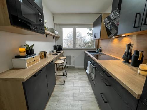 a kitchen with a sink and a counter top at Au cœur des Arènes - Parking privé in Metz