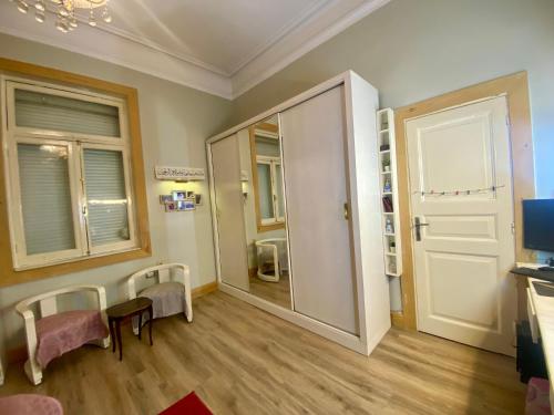une chambre avec une porte et des chaises dans l'établissement Cozy Room in Garden City for females, au Caire