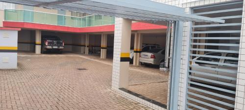 a view of a parking garage with cars parked in it at Hotel em Timbo Grande 