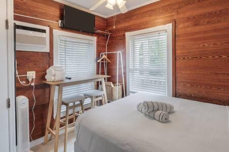 a bedroom with a bed and a table and a desk at Carey's Corner #10 by Brightwild in Key West