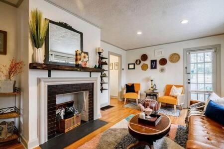 a living room with a fireplace with a tv above it at Pet Friendly Bungalow Steps to Inman Park in Atlanta