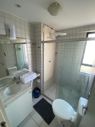 a bathroom with a toilet and a sink and a shower at Flat no melhor lugar de boa viagem in Recife