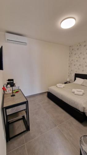 Un dormitorio con una cama y una mesa. en Raggio di Sole 3 en Bari