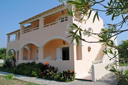 a villa with a view of the front of the house at Marina Studios in Sidari