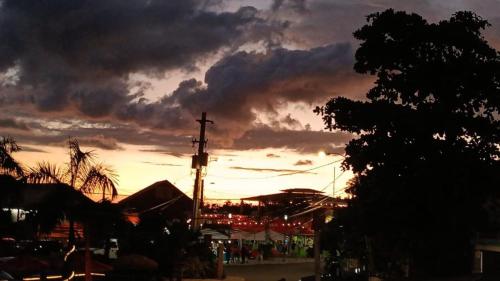 a cross on a pole in front of a sunset at Nautilus by La Jamaca Hotels-Downtown La Parguera in Lajas