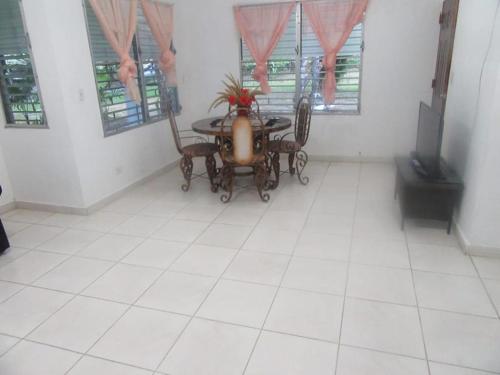a dining room with a table and chairs and windows at yayaya coronado playa exelente precio in Playa Coronado