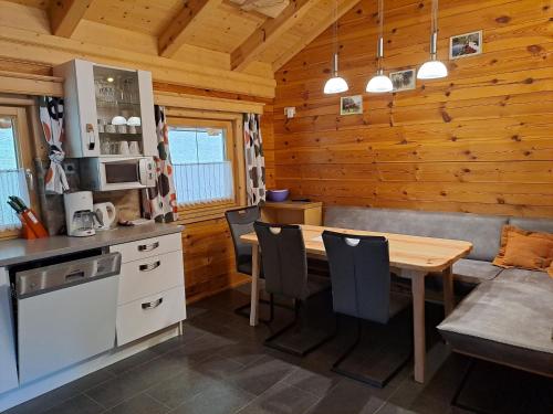 a kitchen with a table and chairs in a cabin at Ferienhaus Lechnerhof in Schladming