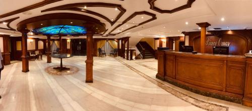 a large lobby with a bar in a building at Prince Omar Nile Cruise - Luxor to Aswan in Aswan