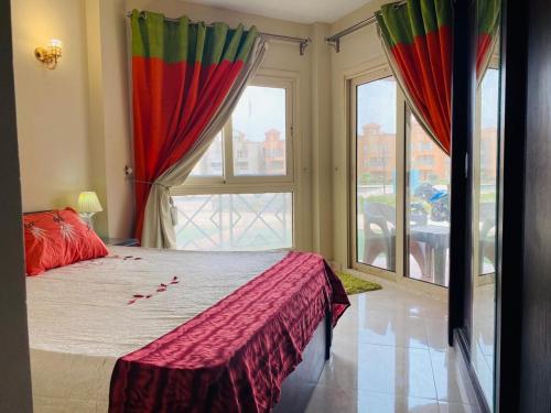 a bedroom with a bed and a large window at Porto Sokhna Water Front For Familis in Ain Sokhna