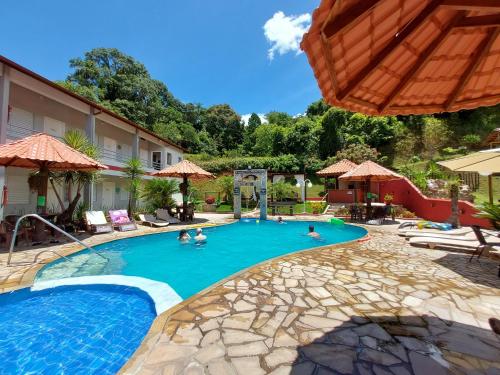 a pool at a hotel with people in it at Pousada Pompeia in Socorro