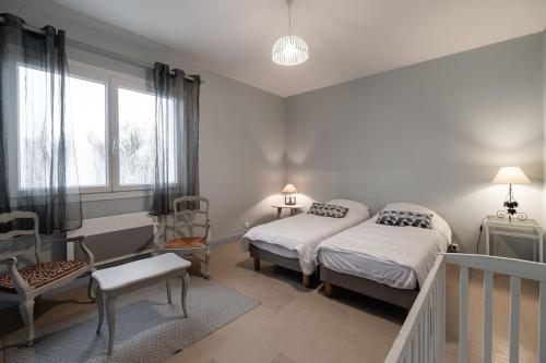 ein Schlafzimmer mit zwei Betten und einem Fenster in der Unterkunft La villa des mouettes in Biscarrosse