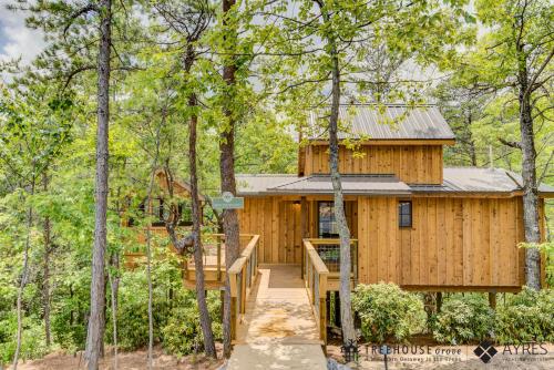 a tree house in the woods with a wooden staircase at The Moosewood in Treehouse Grove at Norton Creek in Gatlinburg