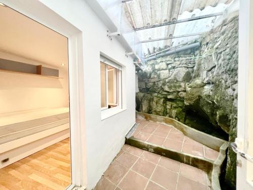 a room with a stone wall and a window at Casa Mariñeira Maruxa in Vilagarcia de Arousa