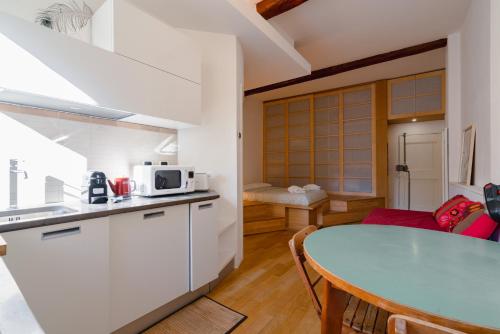 uma cozinha e sala de jantar com uma mesa e um micro-ondas em Casa Santa Caterina em Bolonha