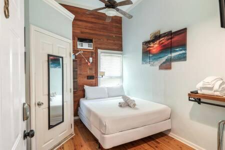 a bedroom with a bed and a ceiling fan at NEW VanGogh Studio by Brightwild- Pool & Balconies in Key West