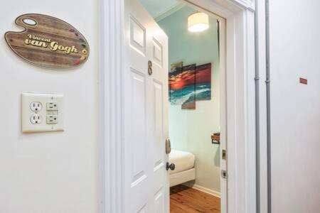 a white door with a sign on it next to a bathroom at NEW VanGogh Studio by Brightwild- Pool & Balconies in Key West