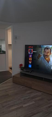 a large flat screen tv sitting in a living room at Le 111 Henri in Gatineau