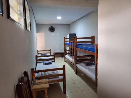 a room with three bunk beds in a room at Hostel My House quartos perto do aeroporto de Guarulhos in Guarulhos