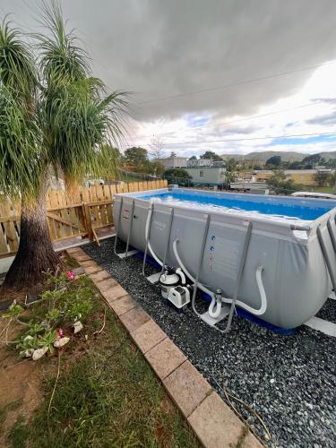 a row of boats sitting next to a swimming pool at Pirata Family House• A 5 min de Poblado Boquerón in Cabo Rojo
