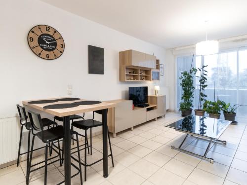 cocina y sala de estar con reloj en la pared en Cosy Corner avec garage et balcon proche Part-Dieu, en Villeurbanne