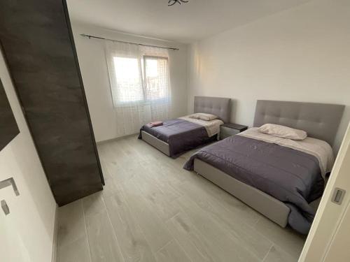 a bedroom with two beds and a window at Casa Giulietta in Padova