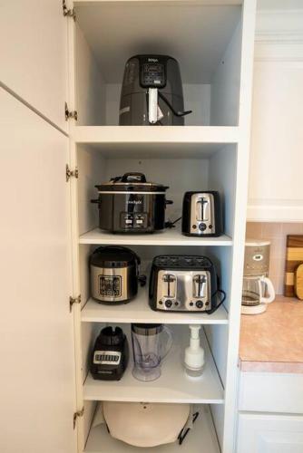 a kitchen pantry with pots and pans and a toaster at Waterfront Home With Heated Pool/Jacuzzi and only 1mile to beach in Marco Island